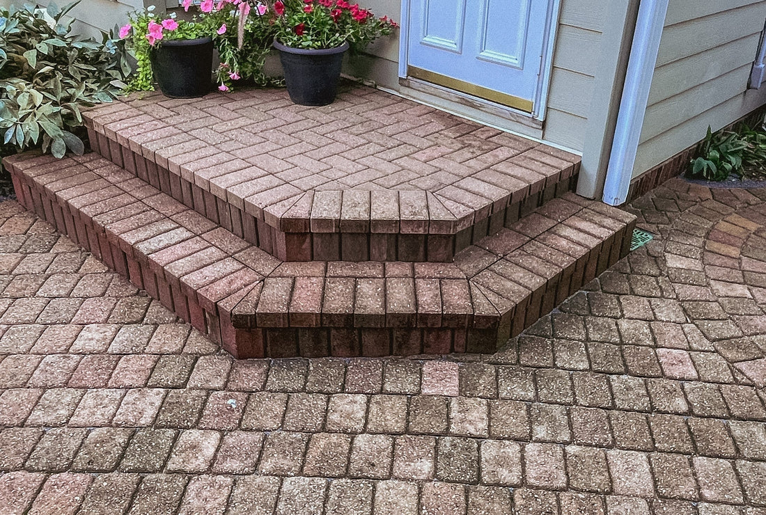 Paver patio steps and landing rebuilt with original stones after drainage correction