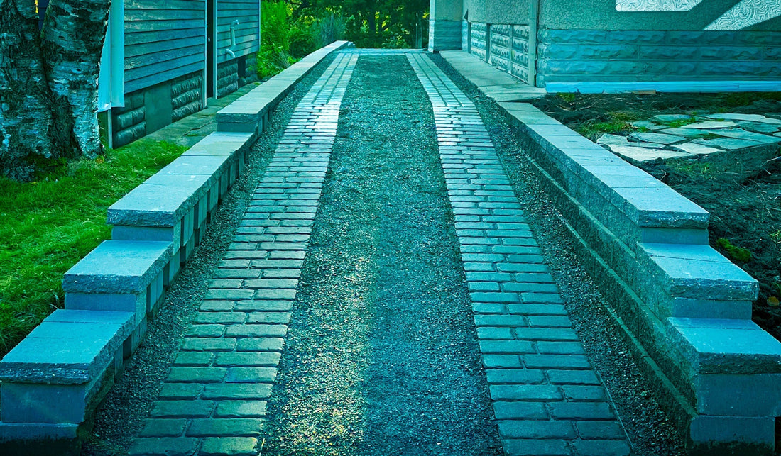 Custom ribbon driveway with concrete and brick pavers by Elzo Landscape in Minneapolis front yard